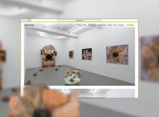 Virtual gallery exhibition space with white walls and gray flooring displaying mixed media artworks including paintings, sculptural objects, and installations featuring warm earth tones and abstract forms.